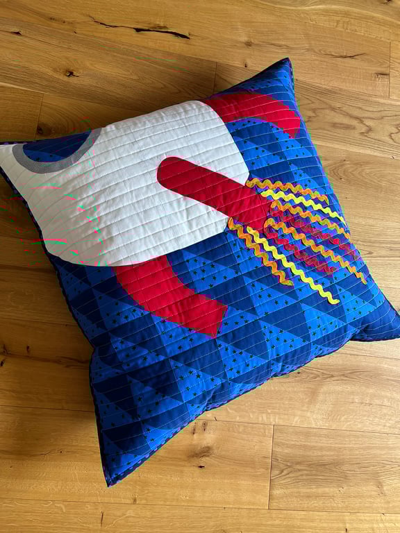 Square quilted floor cushion with space rocket