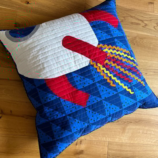 Square quilted floor cushion with space rocket