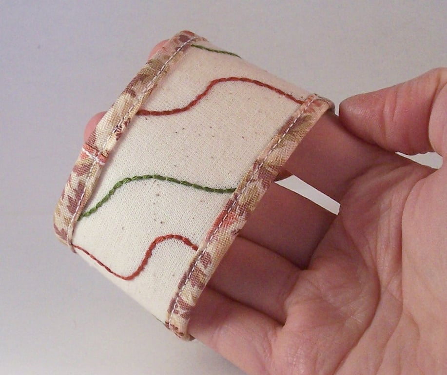 Hand embroidered fabric cuff with simple embroidery