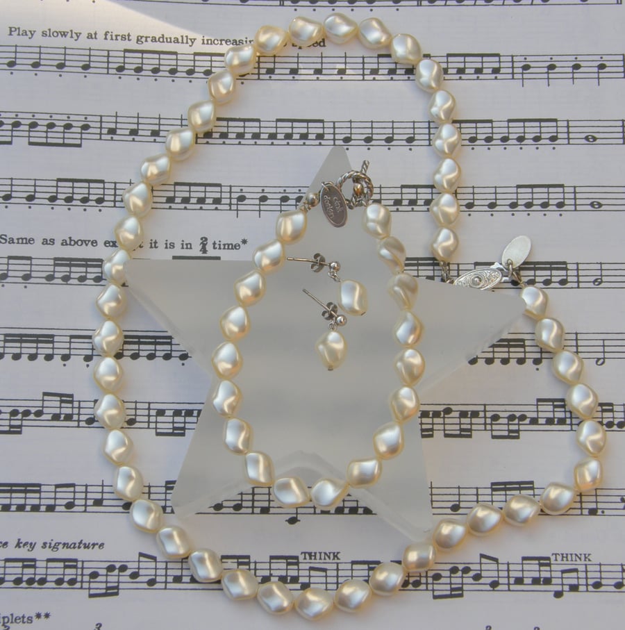 Swarovski ivory shaped pearl necklace and earring set.