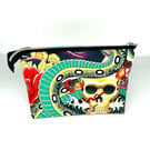 Cosmetic bag with tattoo style print and roses lined with black fabric.