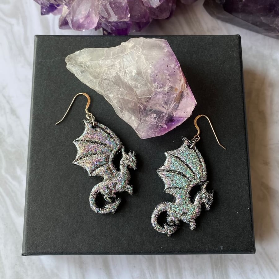 Silver glitter dragon earrings on sterling silver.