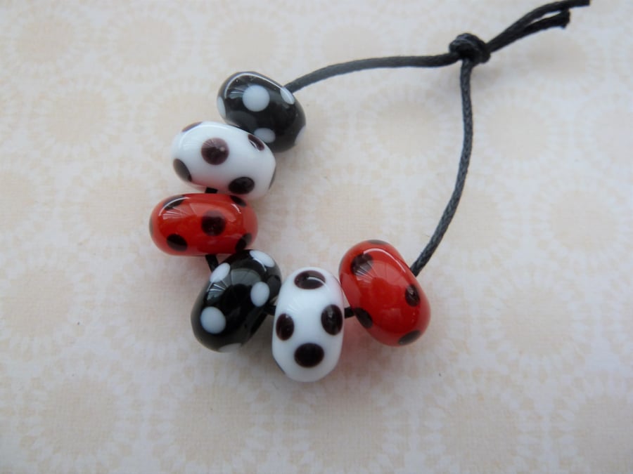 handmade lampwork glass beads, red and black spots