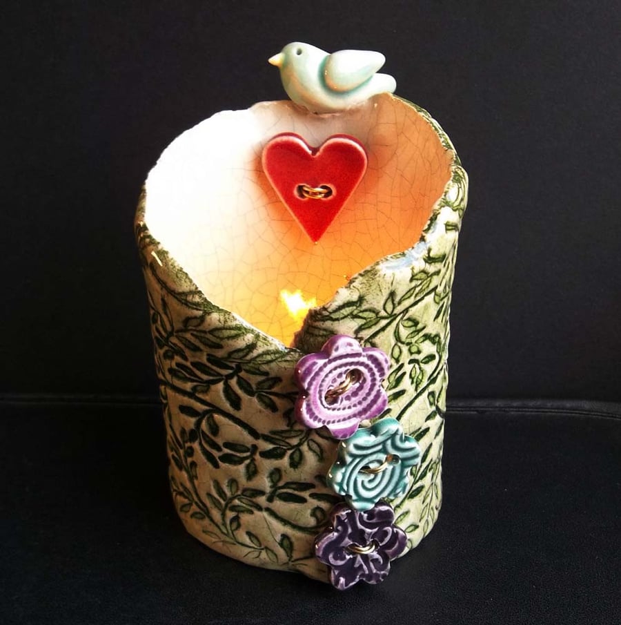 Tall ceramic tea light holder with bird, heart and flowers
