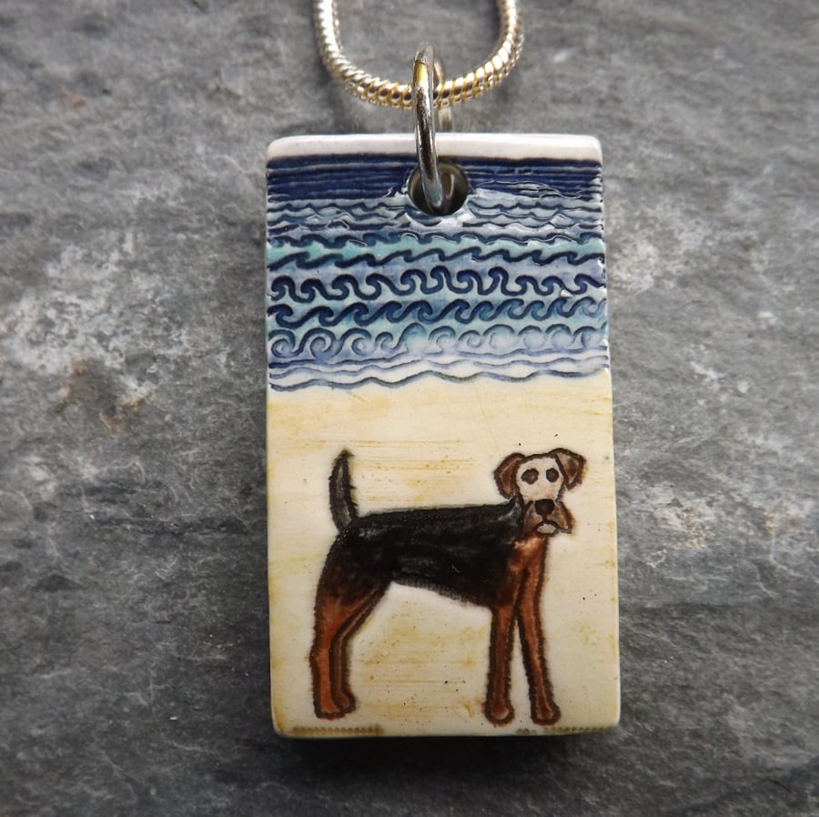 Handmade Ceramic Airedale Terrier dog on the beach pendant