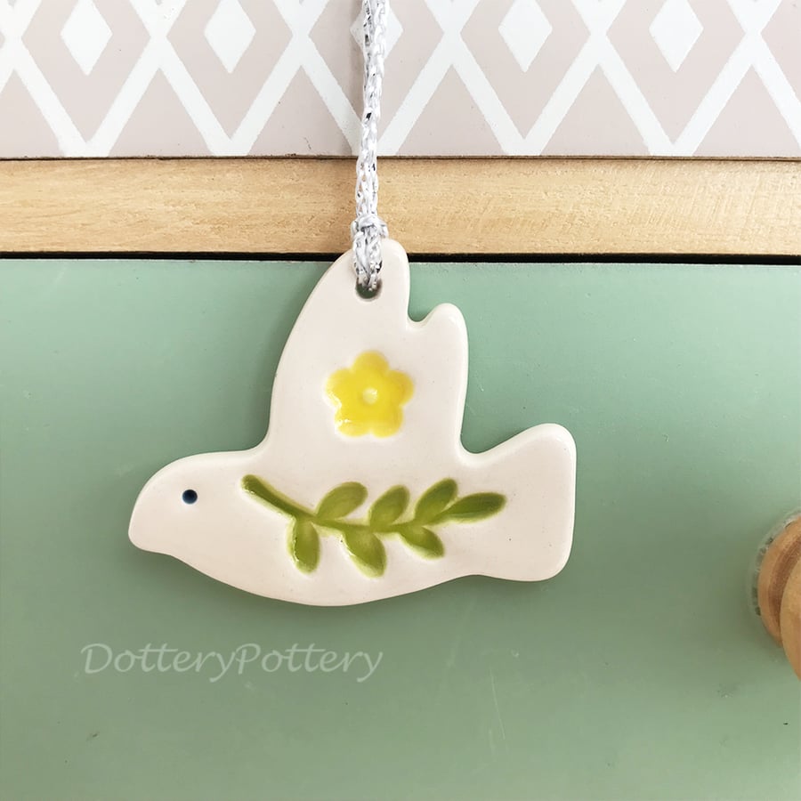 Teeny ceramic dove decoration with leaves and yellow flower