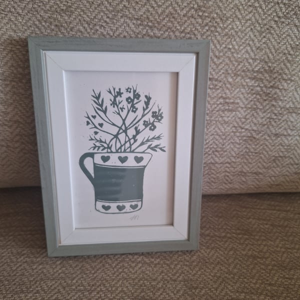 An original handprinted linoprint of a heart decorated jug of grasses & flowers
