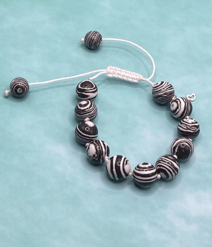 Knotted white cord bracelet with black n white faux fordite stones