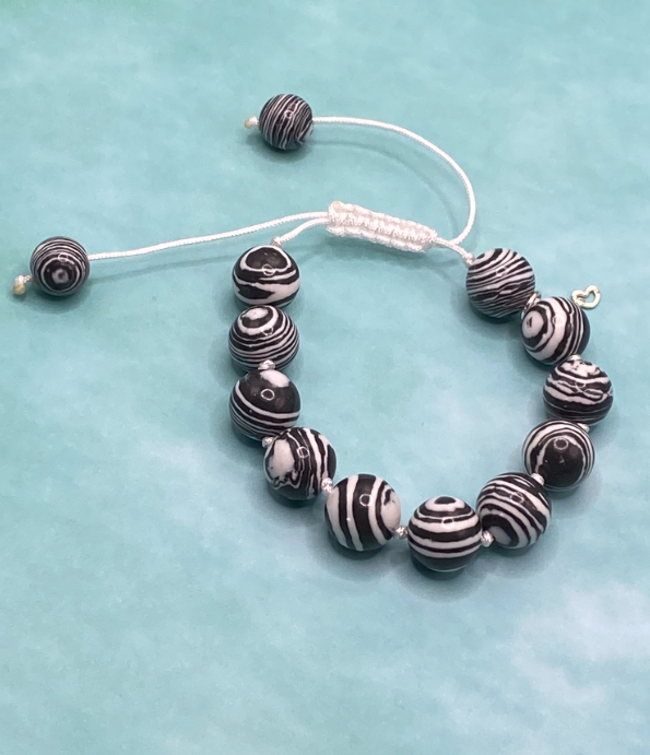 Knotted white cord bracelet with black n white faux fordite stones