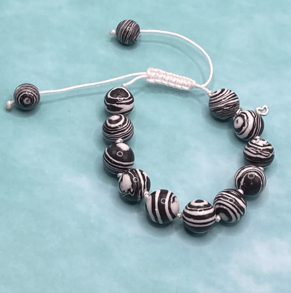 Knotted white cord bracelet with black n white faux fordite stones