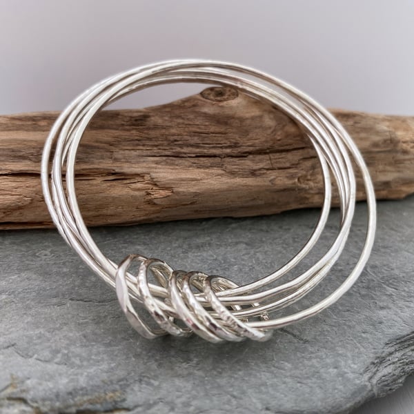 Set of five hammered silver bangles with silver accent rings