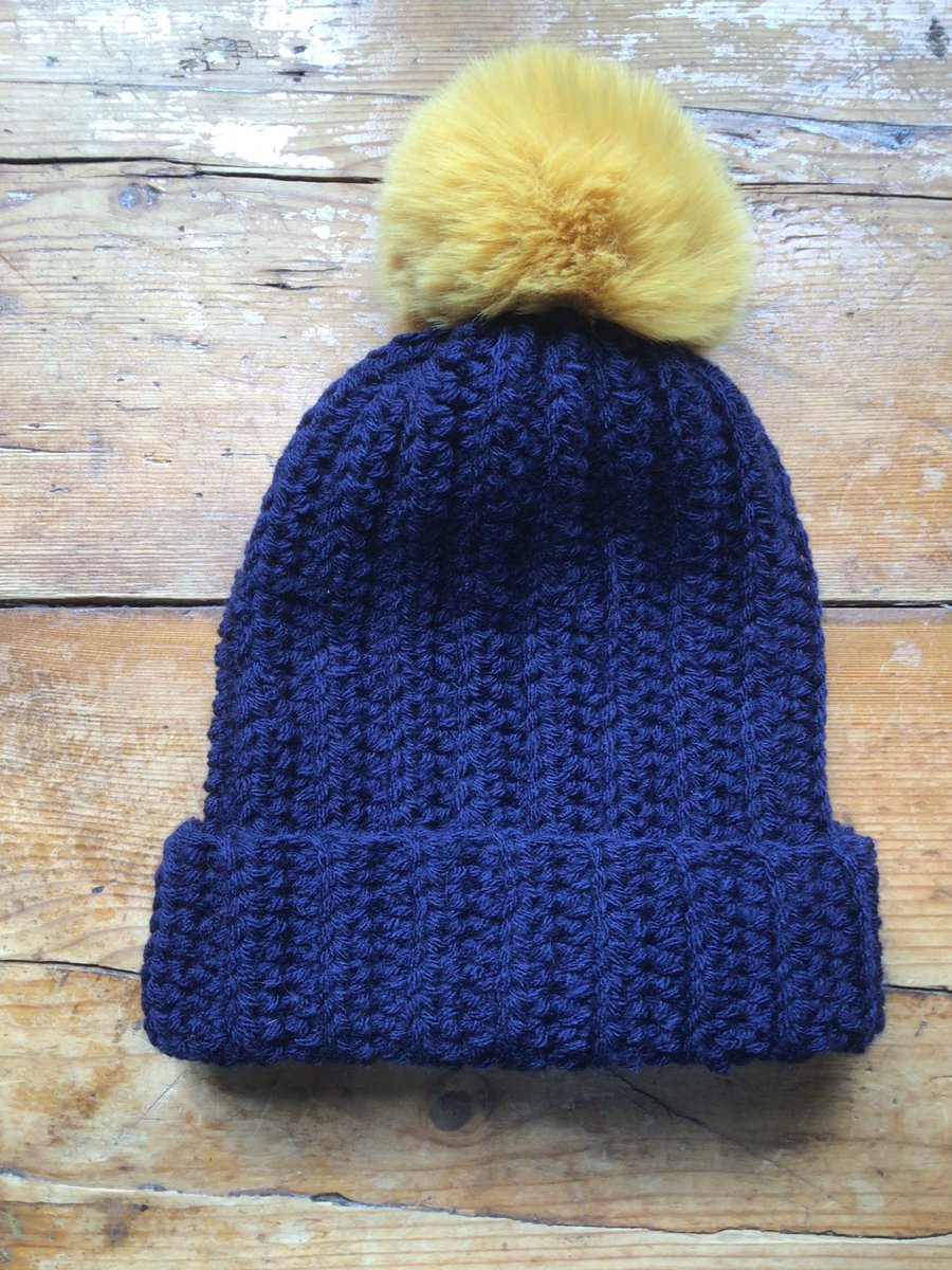 Navy blue Acrylic hat with large mustard faux fur pom Pom 