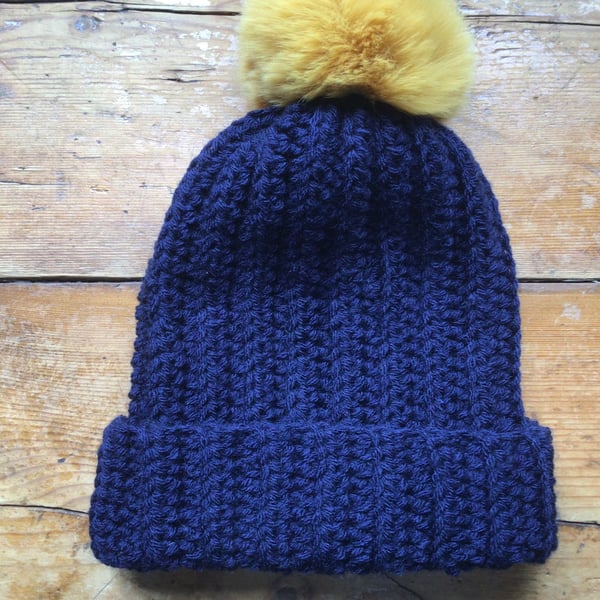 Navy blue Acrylic hat with large mustard faux fur pom Pom 