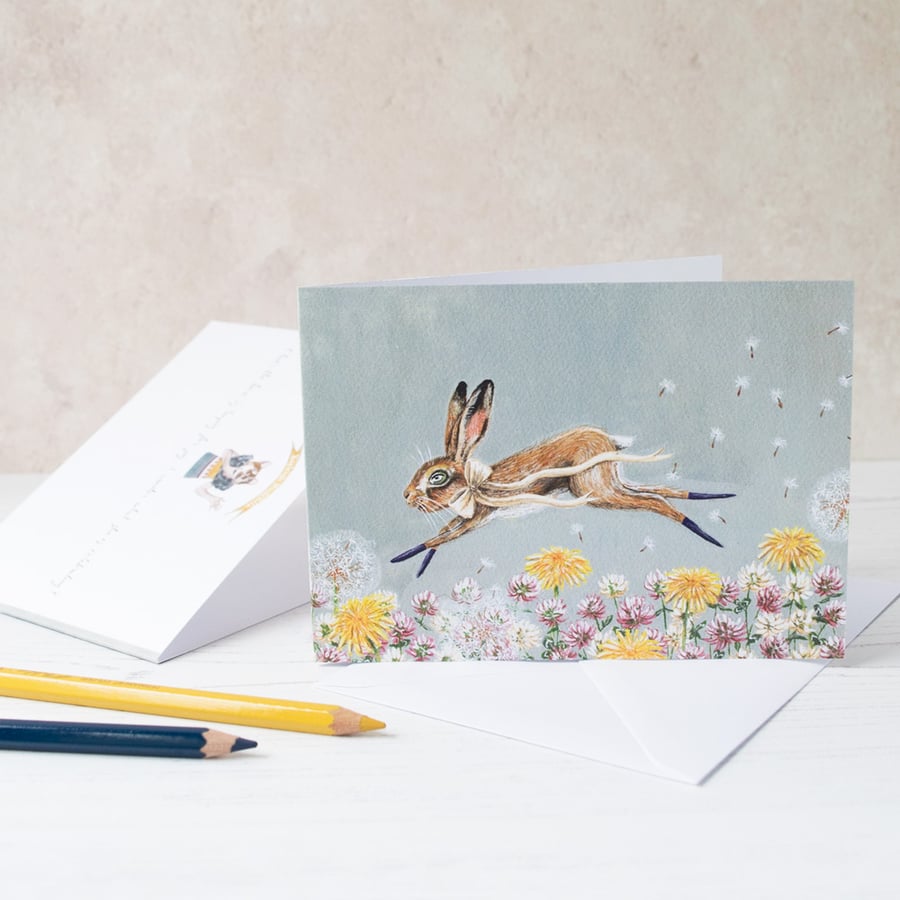 Hare leaping through wild flower meadow greeting note card. A6