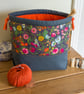 Drawstring project bag made with bright floral print in grey and orange - Image 2