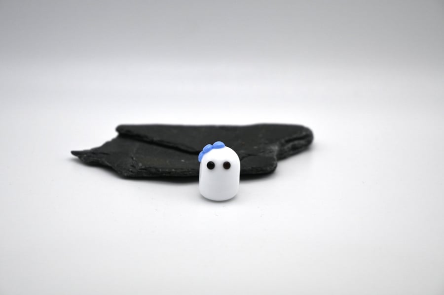 small glass ghost with blue bow