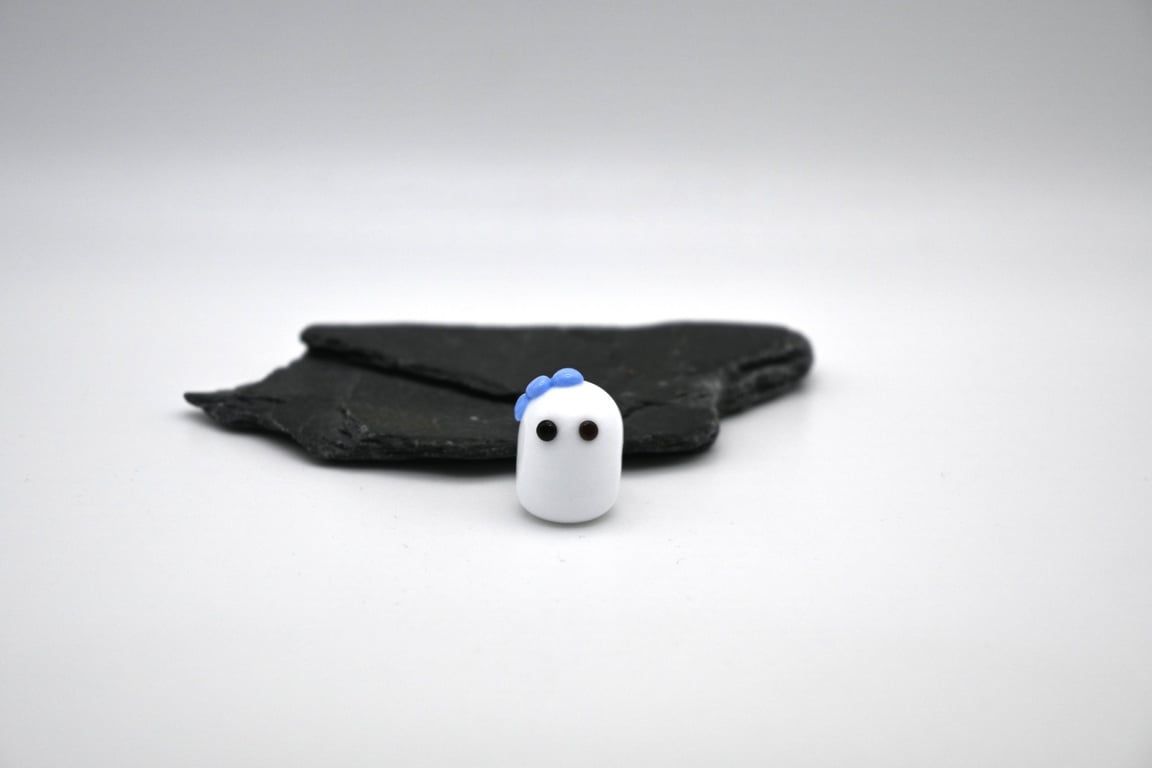 small glass ghost with blue bow