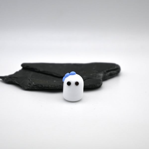 small glass ghost with blue bow