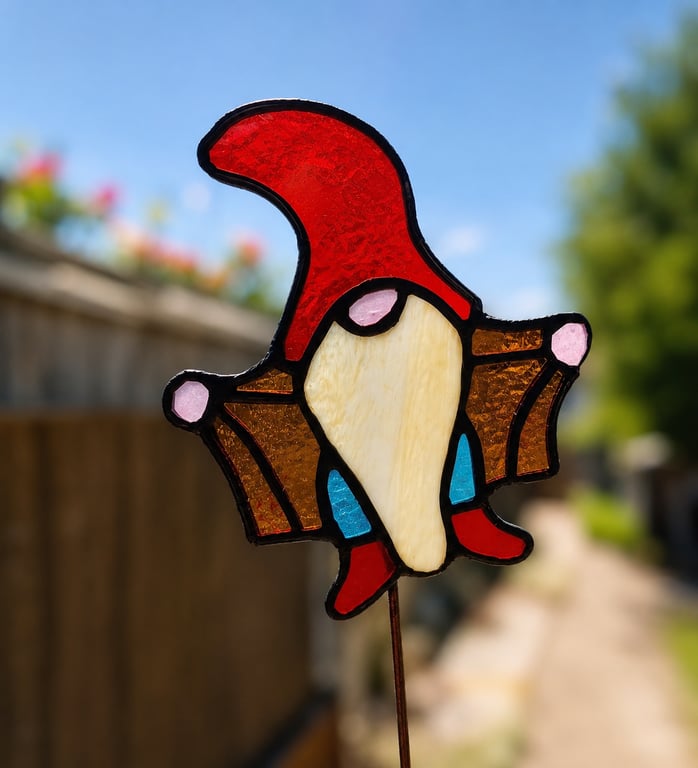 Stained glass Gonk gnome being rude on plant stake