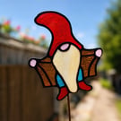 Stained glass Gonk gnome being rude on plant stake