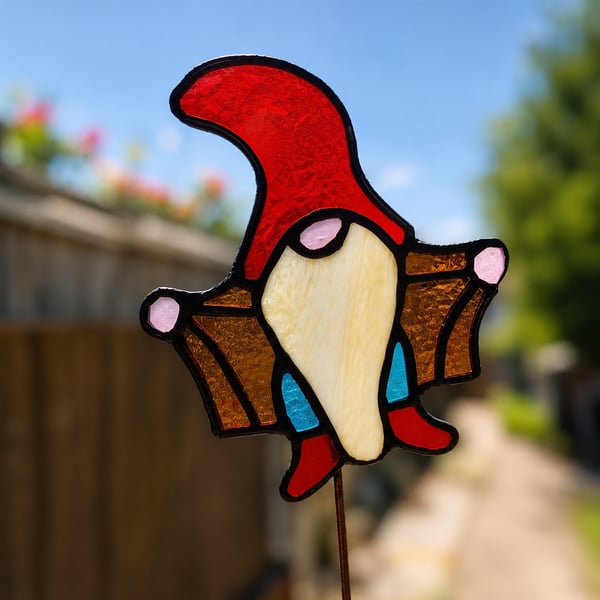 Stained glass Gonk gnome being rude on plant stake