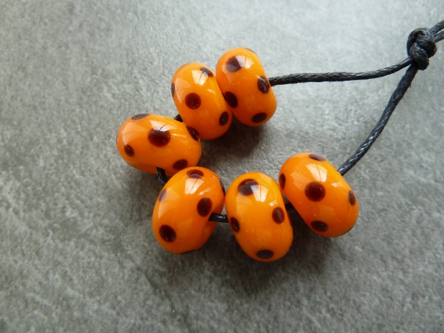 lampwork glass beads, orange and black spots