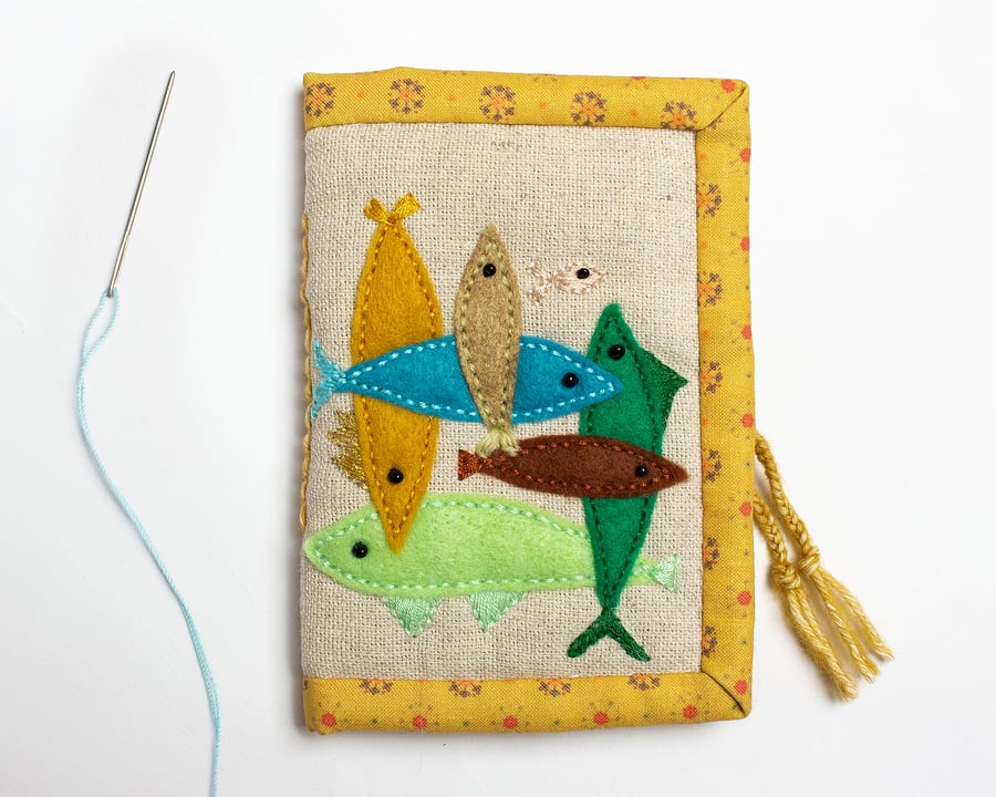 Oatmeal linen needle case with interlocking fish appliqué