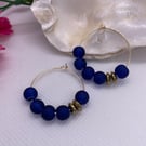 Gold plated hoops with frosted blue glass 