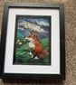 Red fox on a hill watching sheep Needle felt black frame 