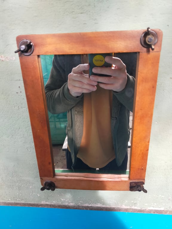 Vintage tennis racket press mirror.