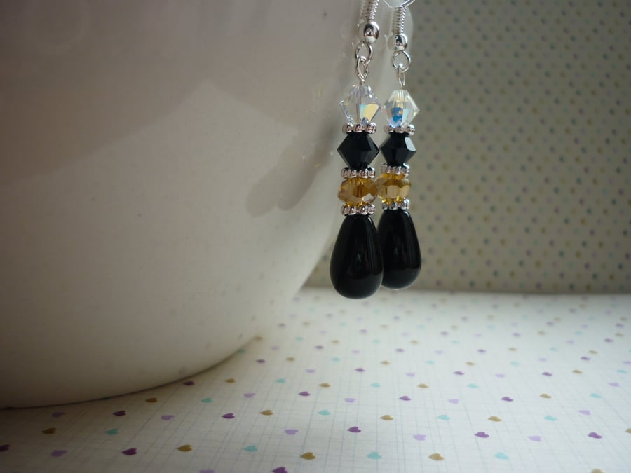 BLACK, CHAMPAGNE, CRYSTAL AND SILVER DANGLE EARRINGS.