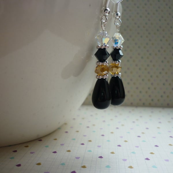 BLACK, CHAMPAGNE, CRYSTAL AND SILVER DANGLE EARRINGS.