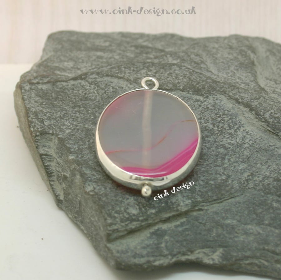 A slice of transparent white with hot pink agate set in sterling silver