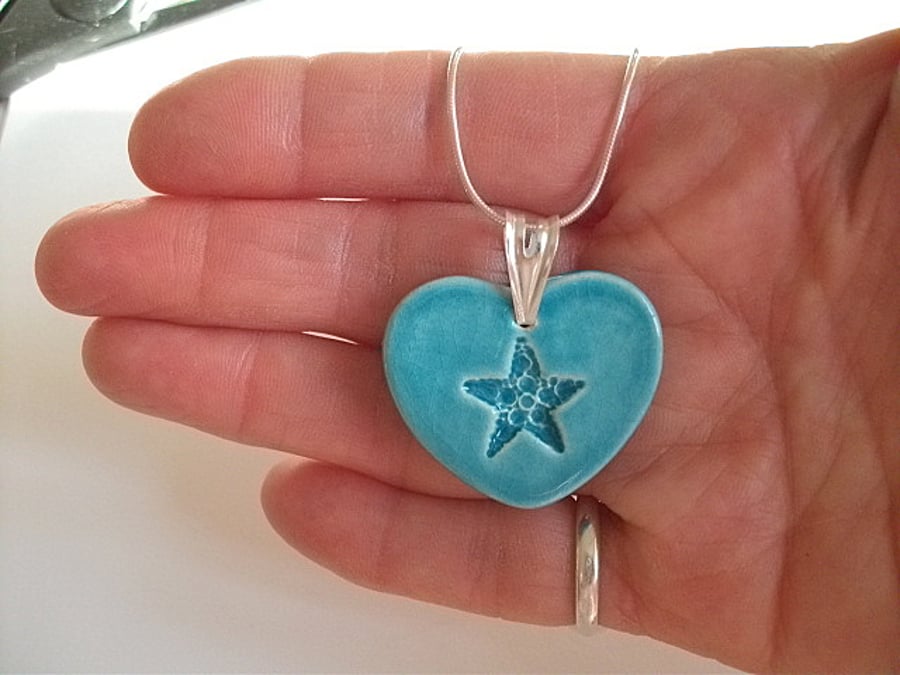 Turquoise ceramic heart pendant with star imprint.  - Sterling silver