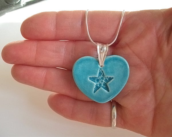 Turquoise ceramic heart pendant with star imprint.  - Sterling silver