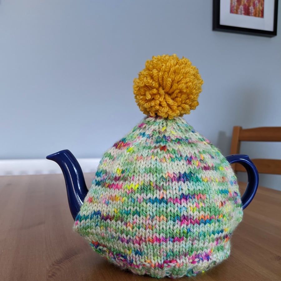 Speckled tea cosy with mustard pom pom