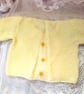 Girl's Knitted White Textured Cardigan with Yellow Daisy Embellishments - Image 2