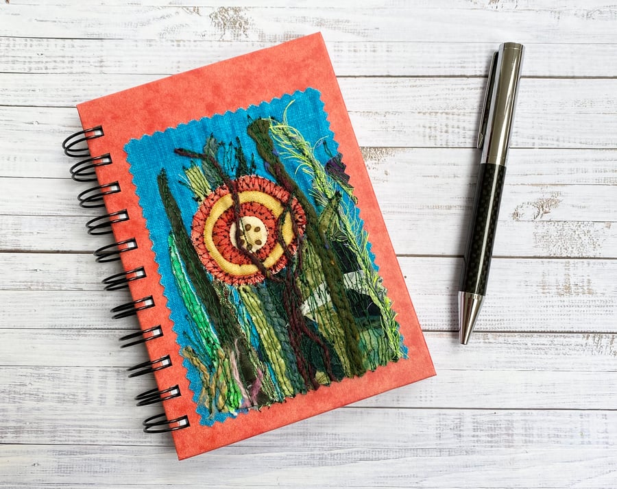 Embroidered flower lined notebook with garden plants.