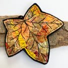 Embroidered up-cycled leaf home decoration.