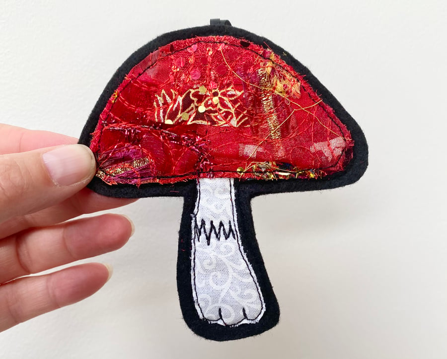 Embroidered up-cycled mushroom home decoration.