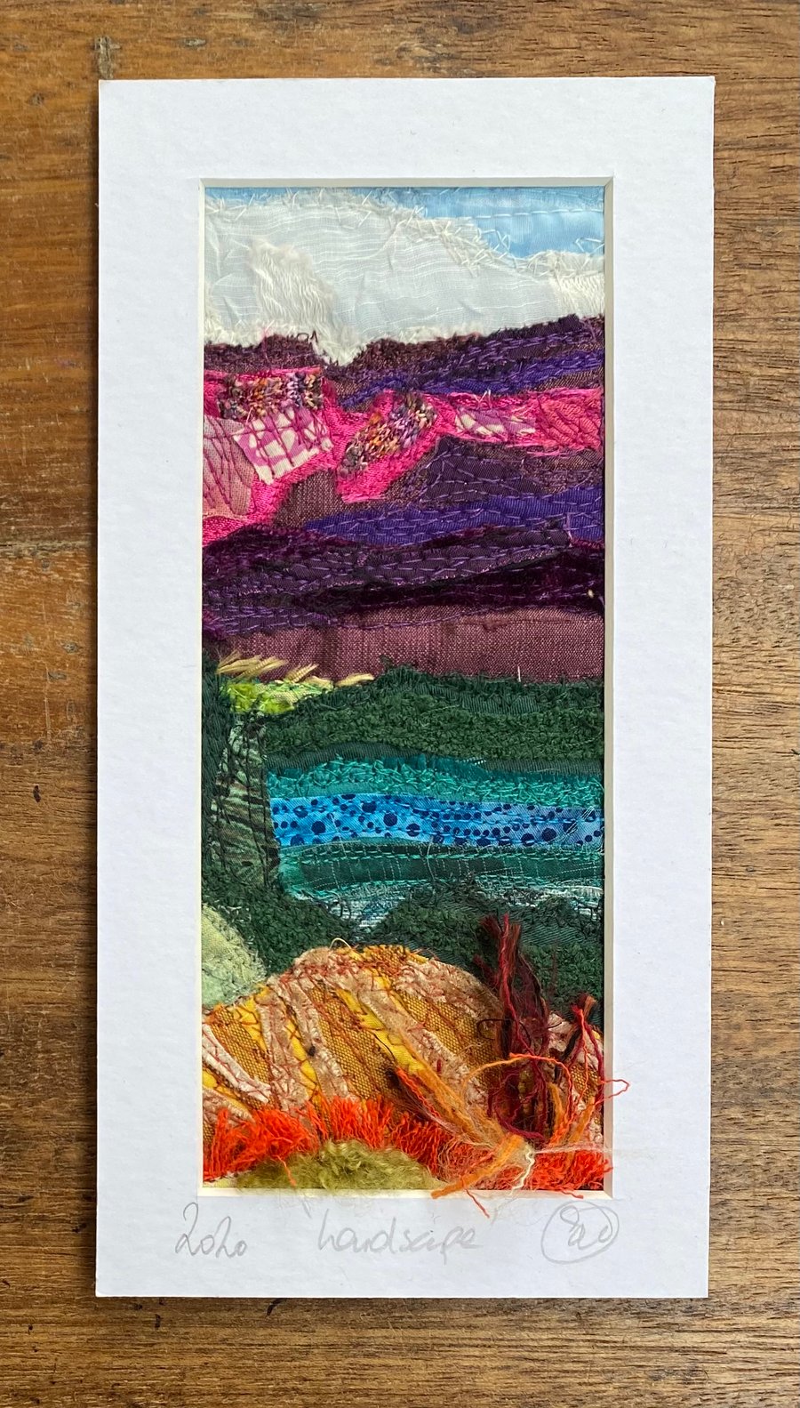 Upcycled and embroidered landscape wall art.