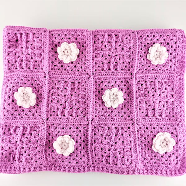 Hot pink crochet baby blanket with 24 pale pink glitter crotchet flowers