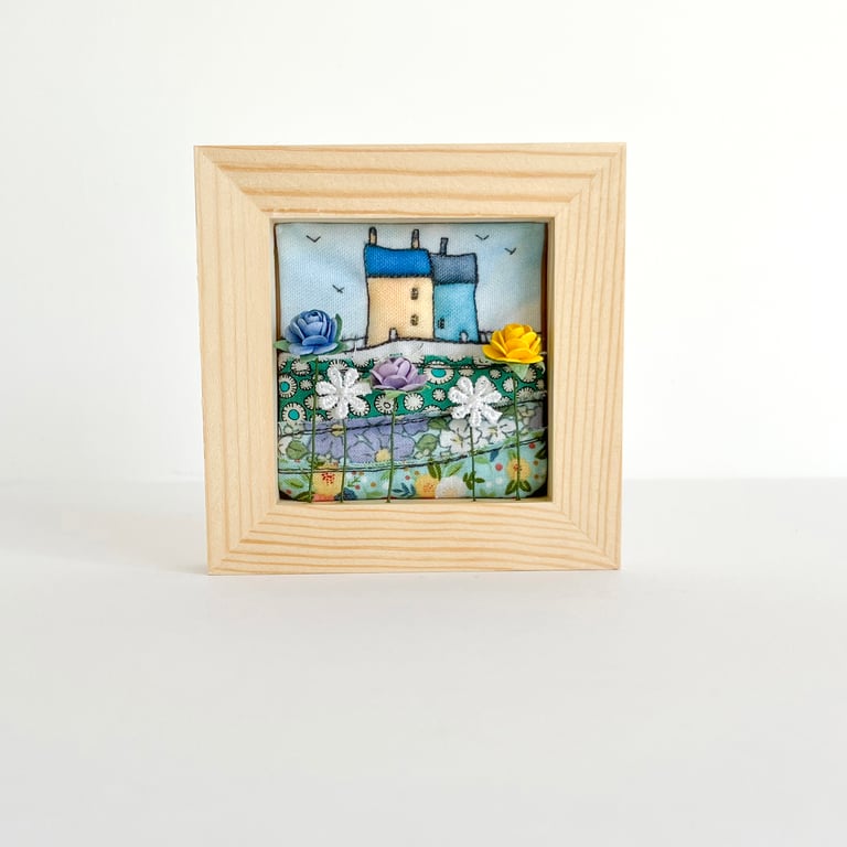 Little 3D fabric picture of houses and flowers, in a small wooden frame