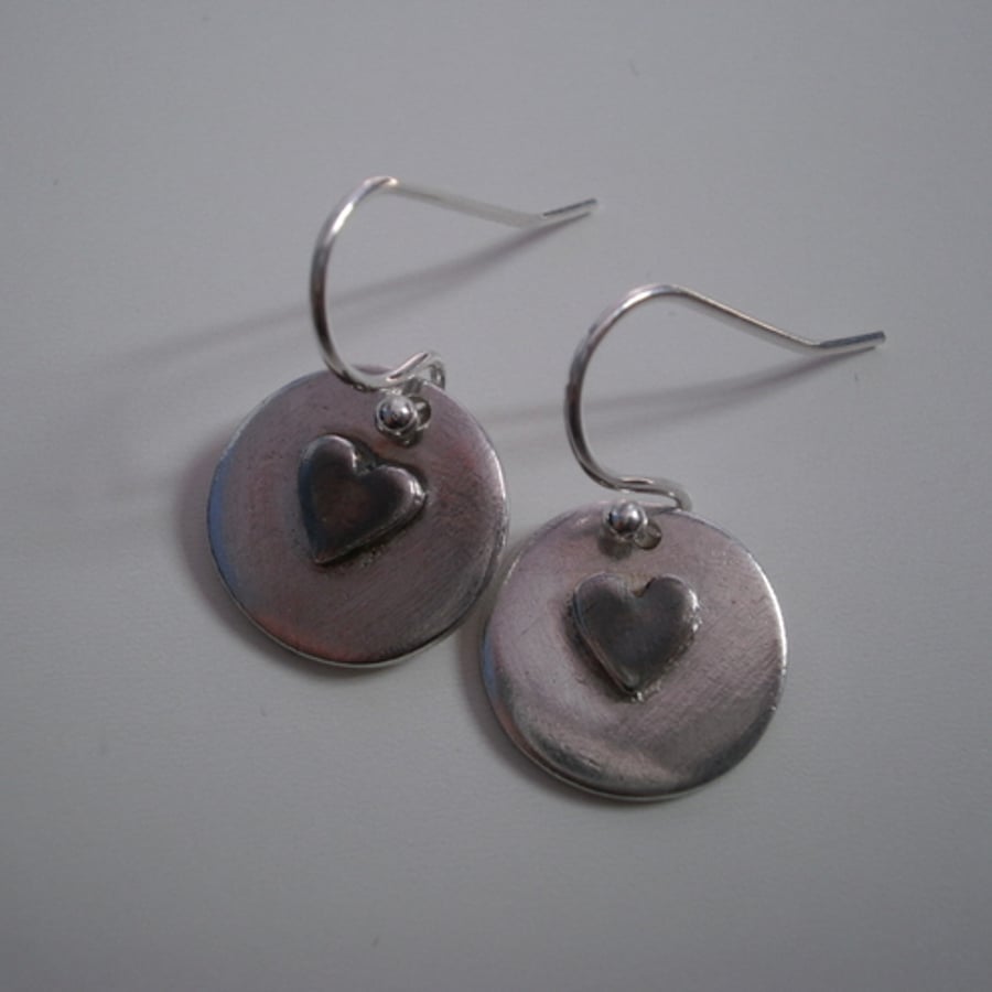 Fine silver round earrings with oxidised heart decoration