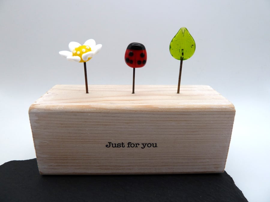 wooden block, ladybird and daisy