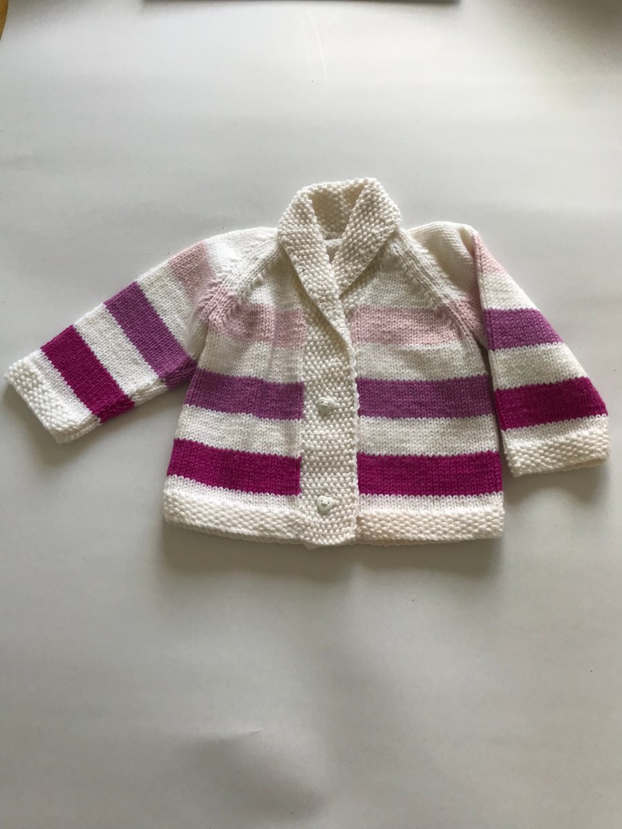 Hand knitted striped cardigan for a baby