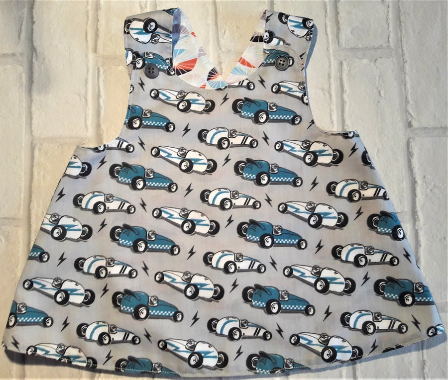 Reversible crossover pinafore dress with contemporary racing car design