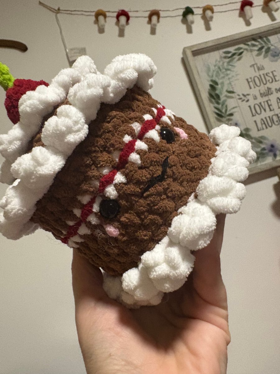 Chocolate crochet cake with cherry on top.