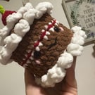 Chocolate crochet cake with cherry on top.