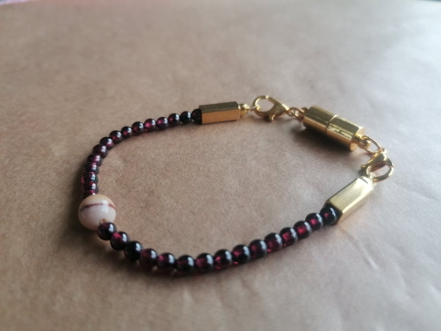 Australian Zebra stone and red beaded bracelet with a cylindrical magnetic. 